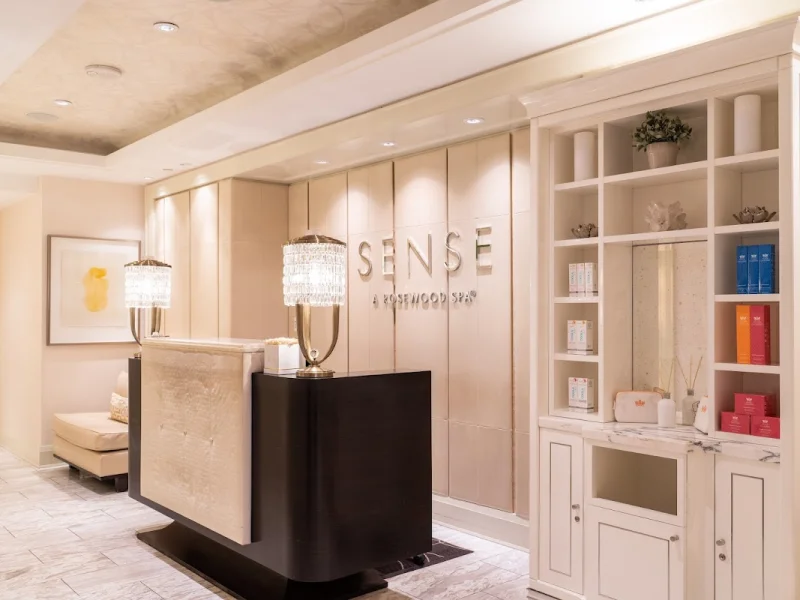 Elegant spa reception with branded entry and luxury product displays