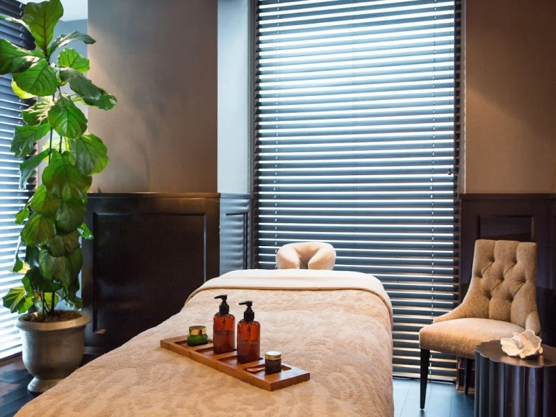 Private massage room with treatment table, oils, and calming decor