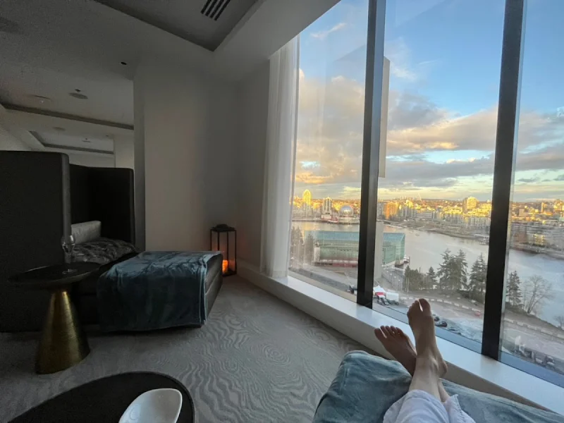 Relaxation lounge with floor-to-ceiling windows and panoramic waterfront city views