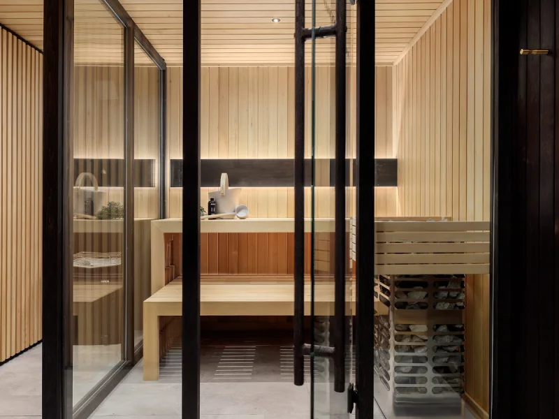 Modern glass-front sauna suite with minimalist spa design