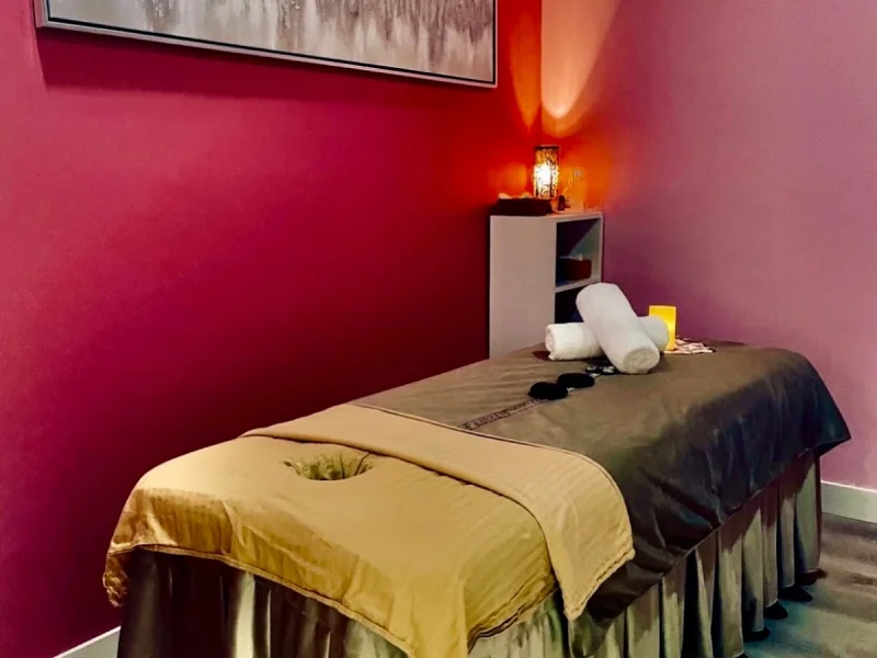 Relaxing massage treatment room with heated table and soft ambient lighting