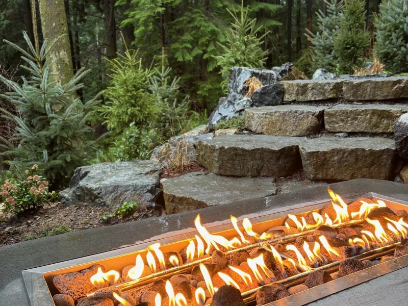 Stone fire feature nestled in a forested thermal sanctuary setting