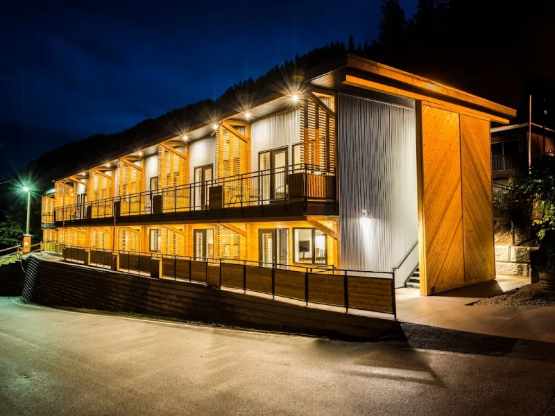 Modern resort exterior at night with warm architectural lighting