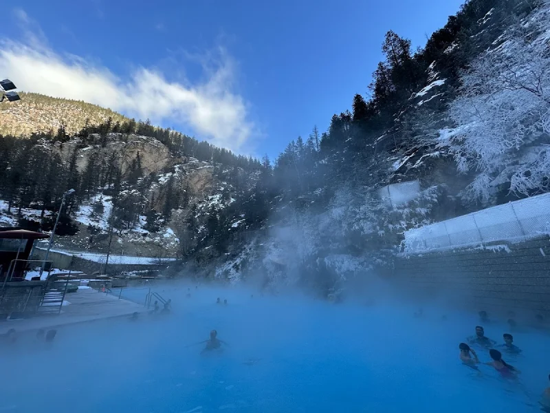 Thermal pool steaming in a snowy canyon at Radium Hot Springs