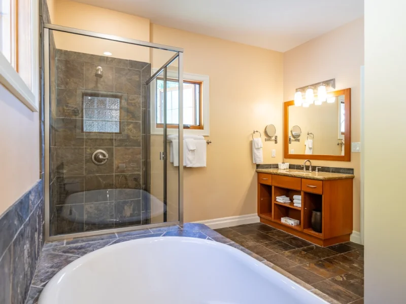 Luxury spa bathroom with freestanding soaking tub and rainfall shower