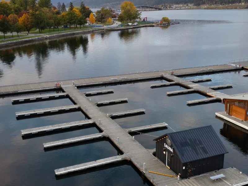 Aerial view of floating sauna docks on calm lake water