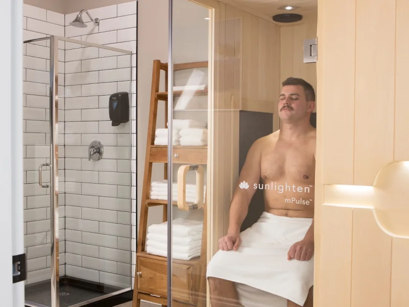 Infrared sauna treatment room with shower and towels
