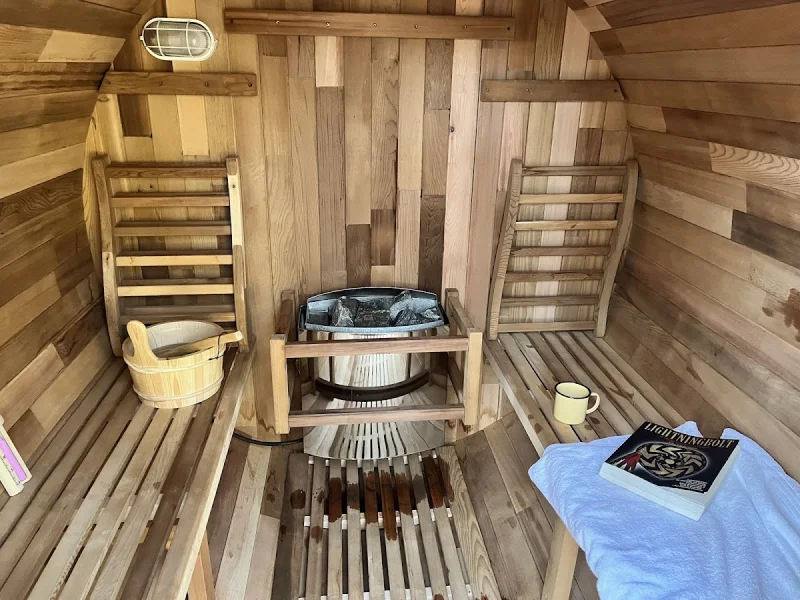 Cozy cedar sauna interior with wooden benches and stove heater