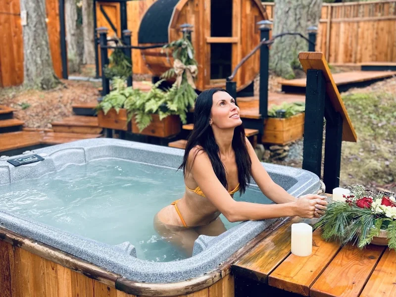 Guest relaxing in an outdoor hot tub at a forest spa retreat